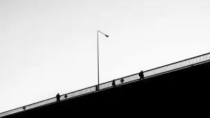 people walking on a bridge