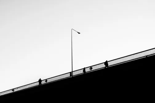 people walking on a bridge