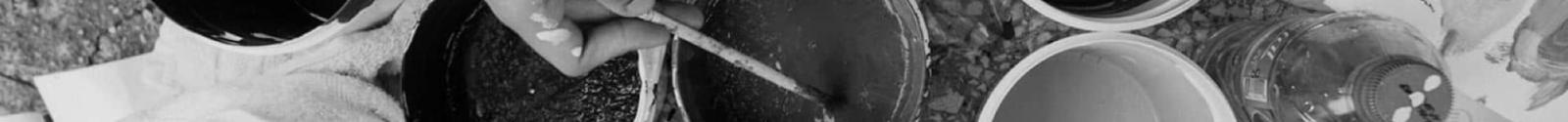 Overhead view of hands holding coffee cups in a circle, black and white photograph