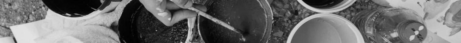 Overhead view of hands holding coffee cups in a circle, black and white photograph