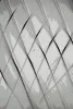 White translucent panels arranged in overlapping diamond pattern creating geometric shadows